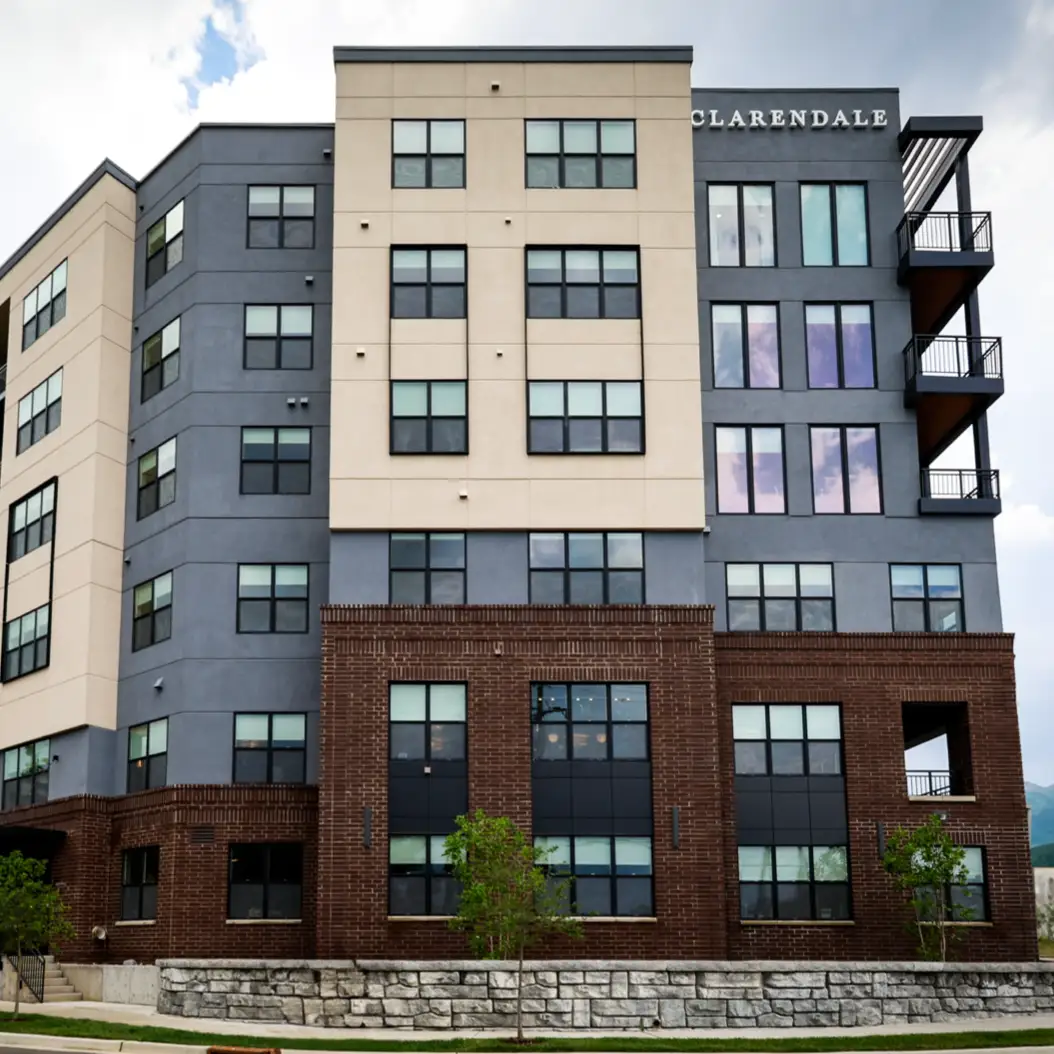 a man and woman smiling and holding a cup of coffee