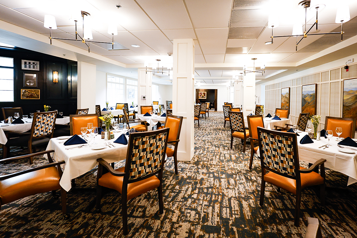 a man and woman smiling and holding a cup of coffee